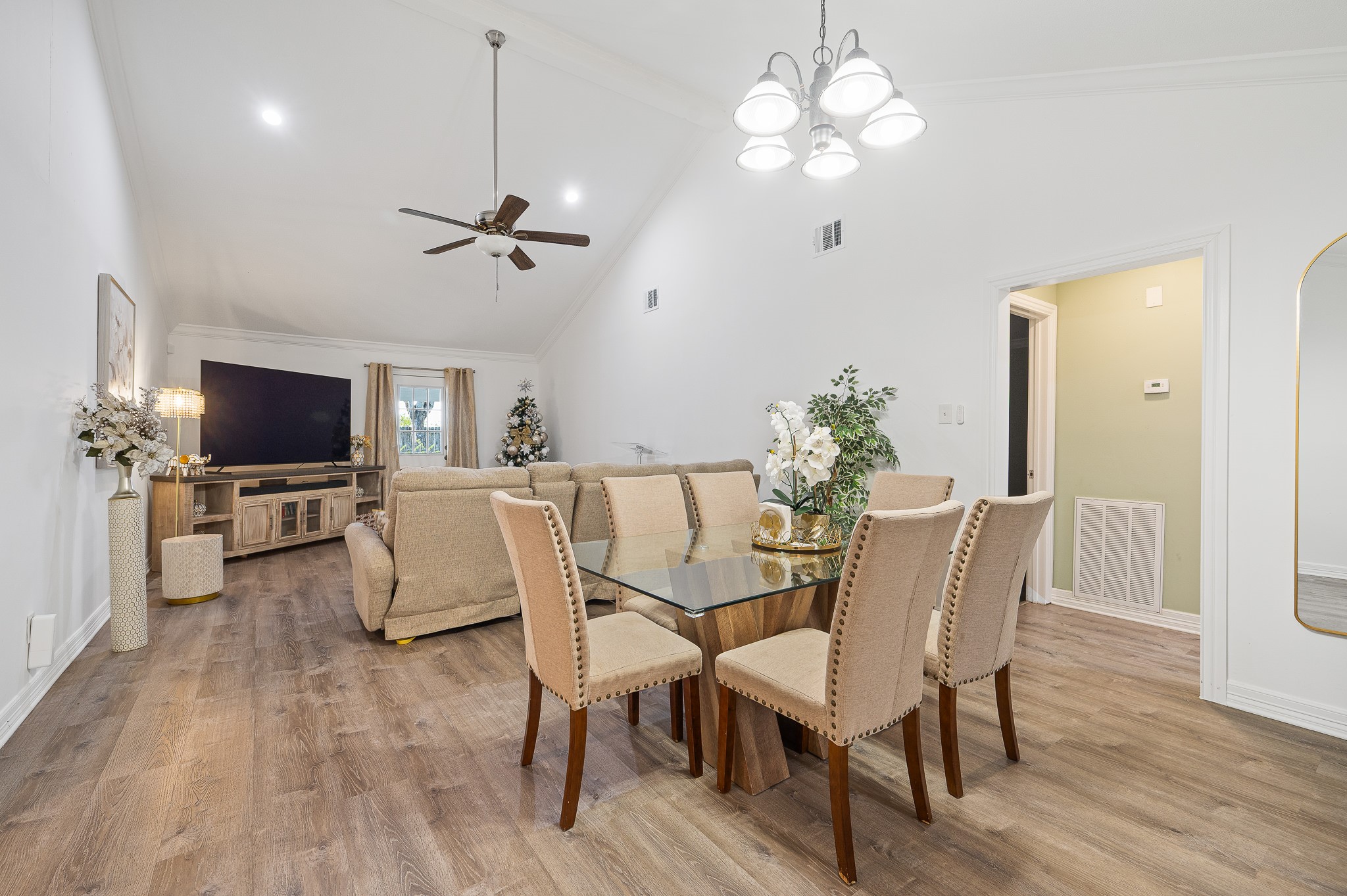 3823 Shadow Trail Houston, TX 77084 - Photo 6 of 29 a view of a dining room with furniture a chandelier and wooden floor