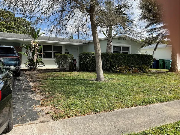 a front view of a house with a yard chairs and table