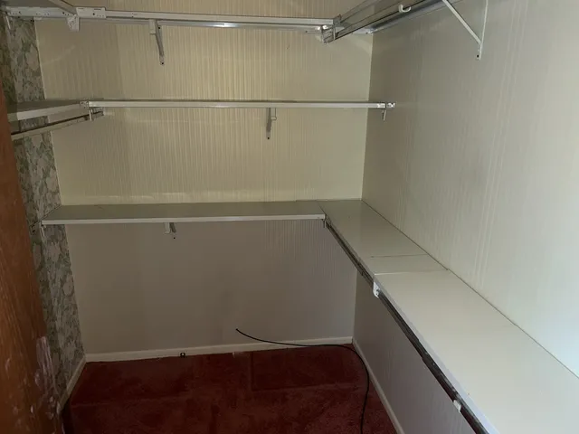 a view of storage and utility room with racks on the wall