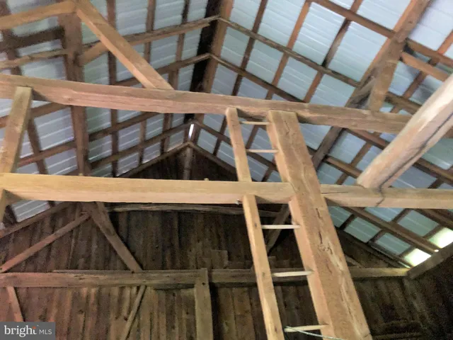 a backyard of a house with barbeque oven and outdoor seating