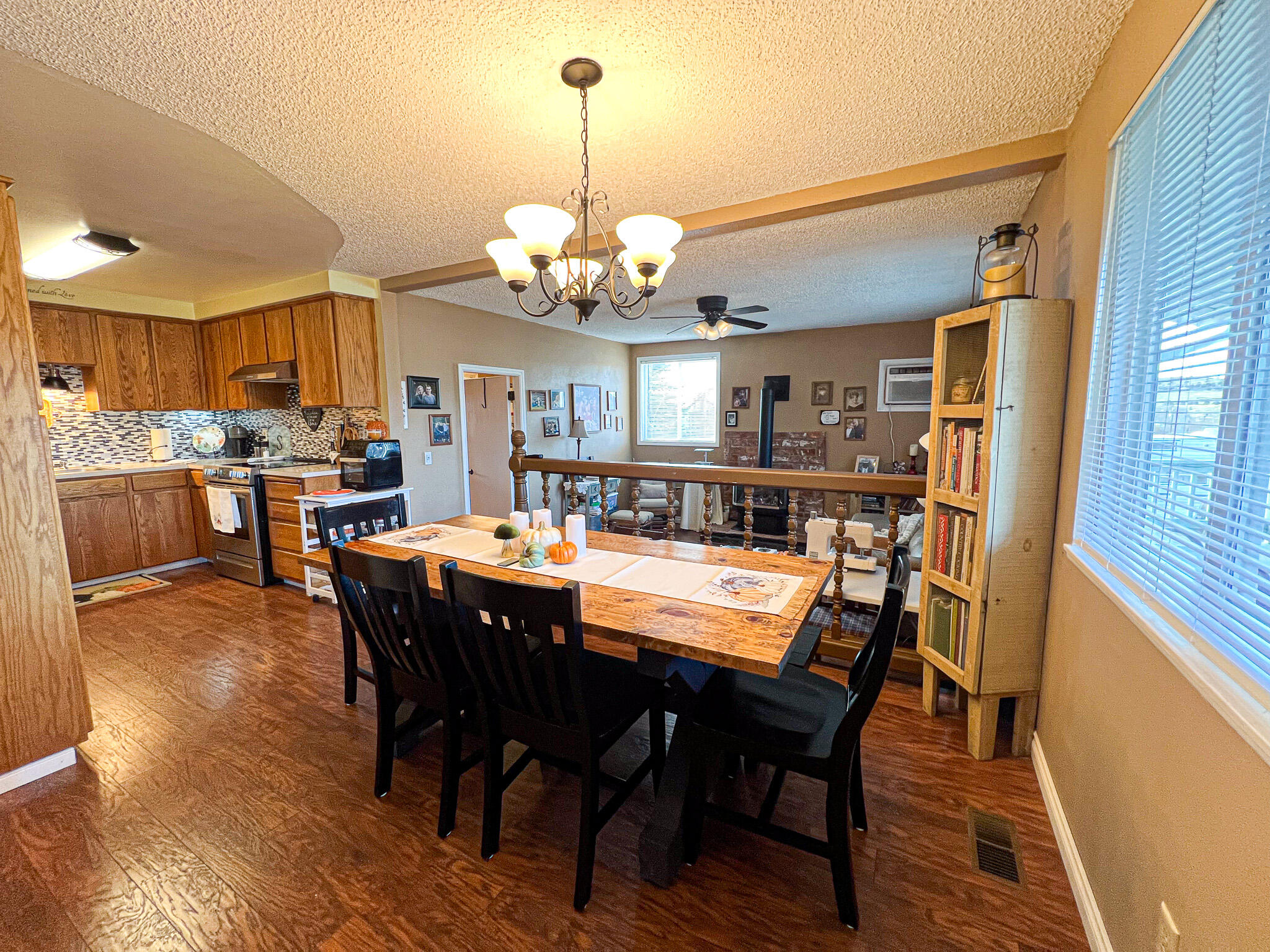 1225 East B Street Fossil, OR 97830 - Photo 8 of 33 a view of a dining room with furniture a chandelier and wooden floor