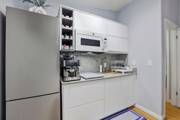 a kitchen with stainless steel appliances a refrigerator and a sink
