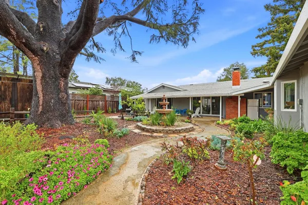 a front view of a house with a yard outdoor seating and garden