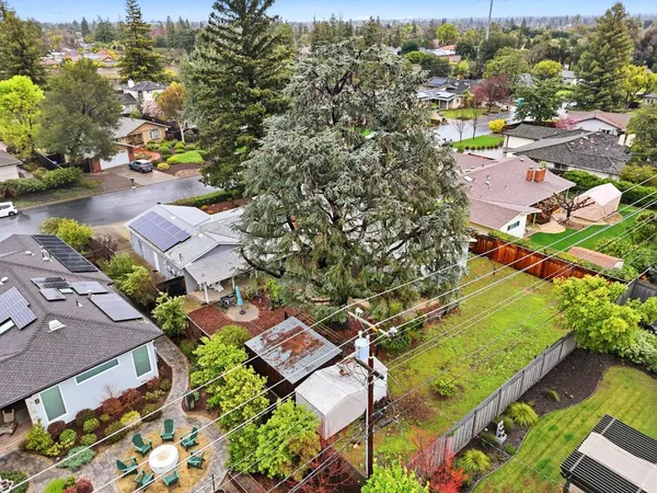 an aerial view of a house with a garden and a yard