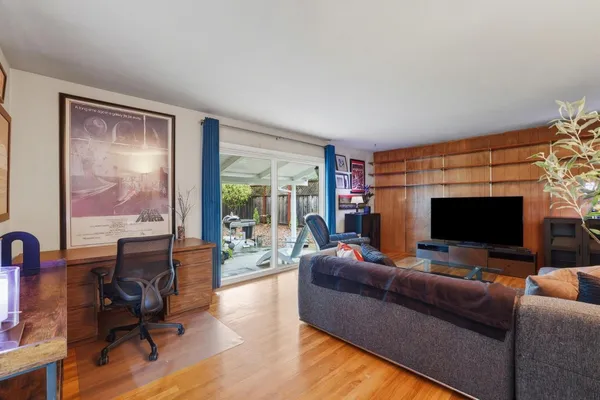 a living room with furniture and a flat screen tv
