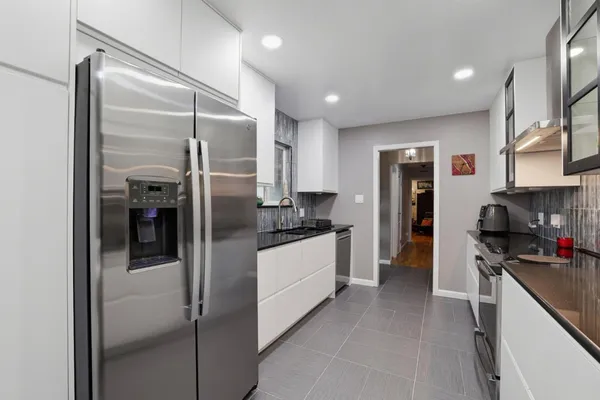 a kitchen with stainless steel appliances refrigerator and microwave