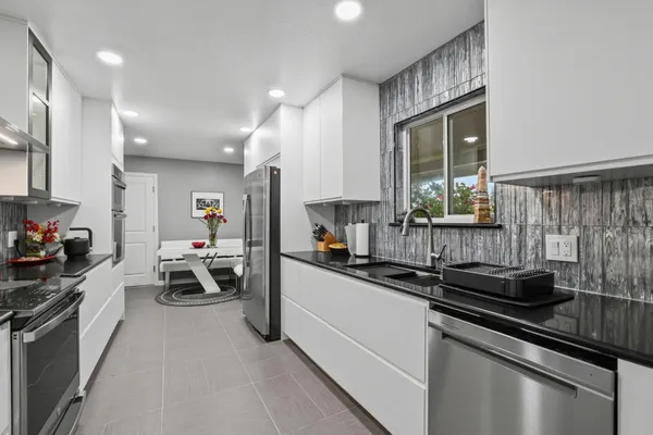 a kitchen that has a sink and a stove in it