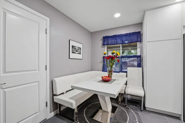 a view of a dining room with furniture and window
