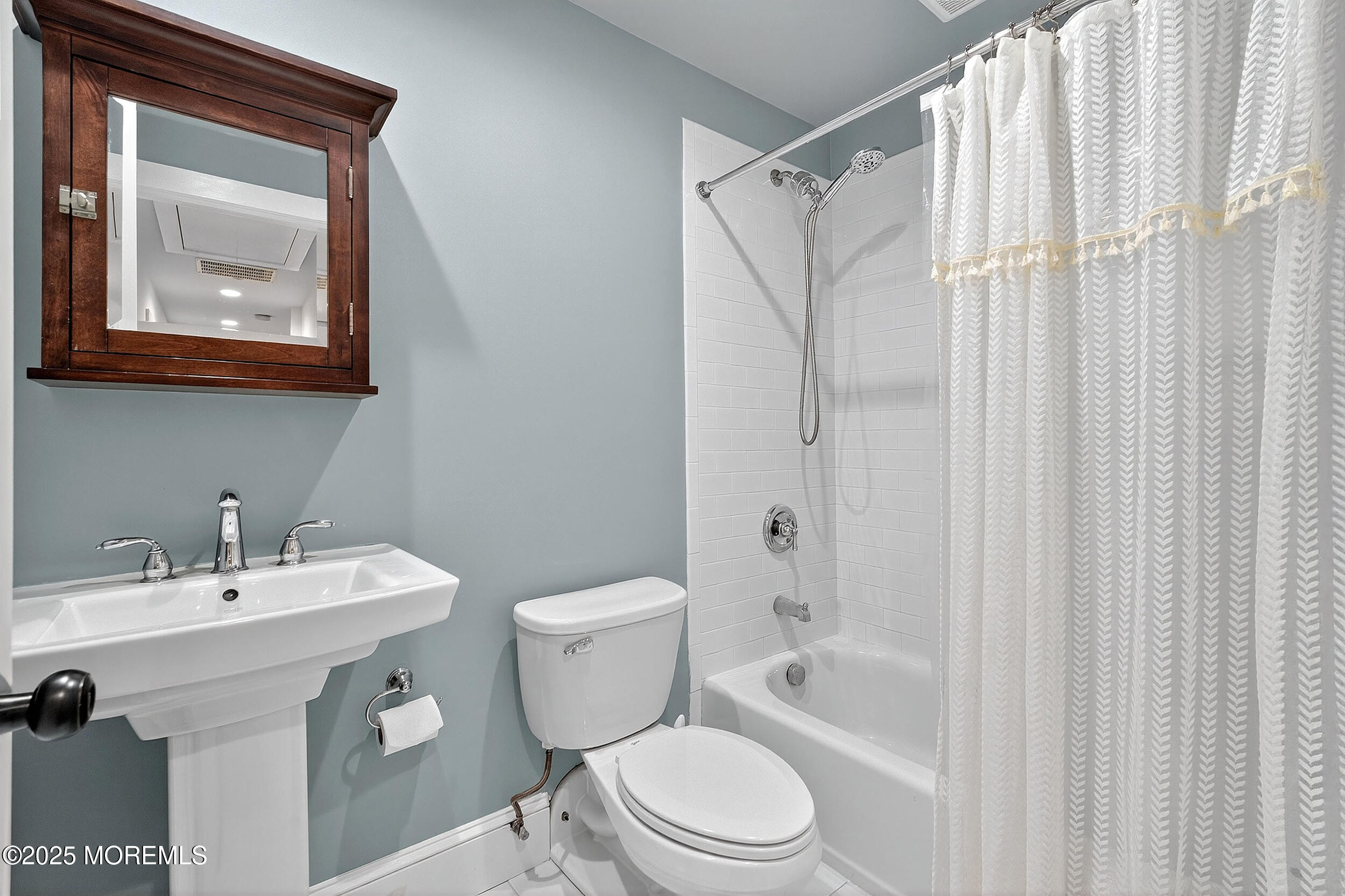 1961 Jumping Brook Road Tinton Falls, NJ 07753 - Photo 1 of 45 a bathroom with a toilet a sink and a bathtub