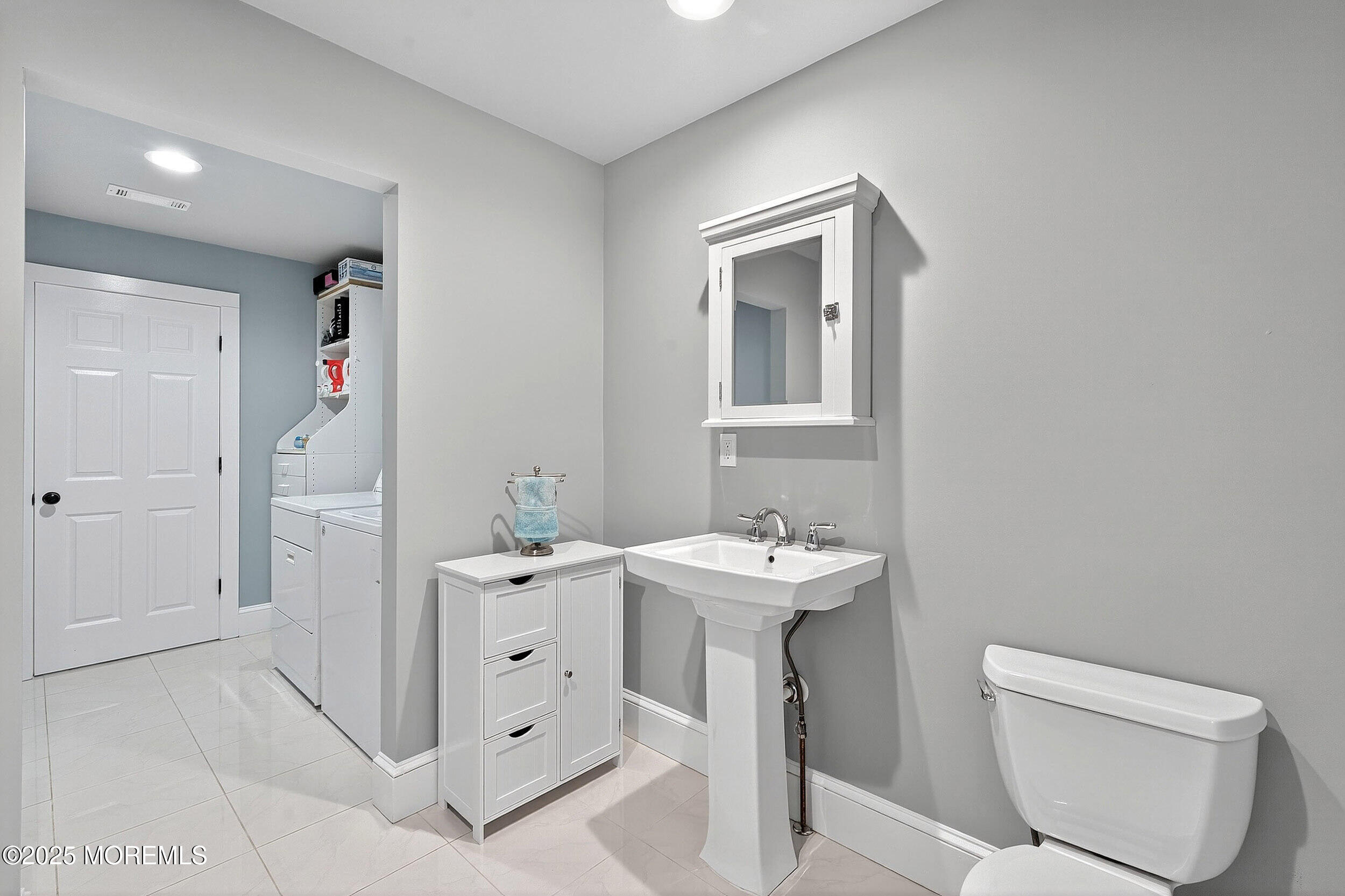 1961 Jumping Brook Road Tinton Falls, NJ 07753 - Photo 23 of 45 a bathroom with a toilet sink and mirror