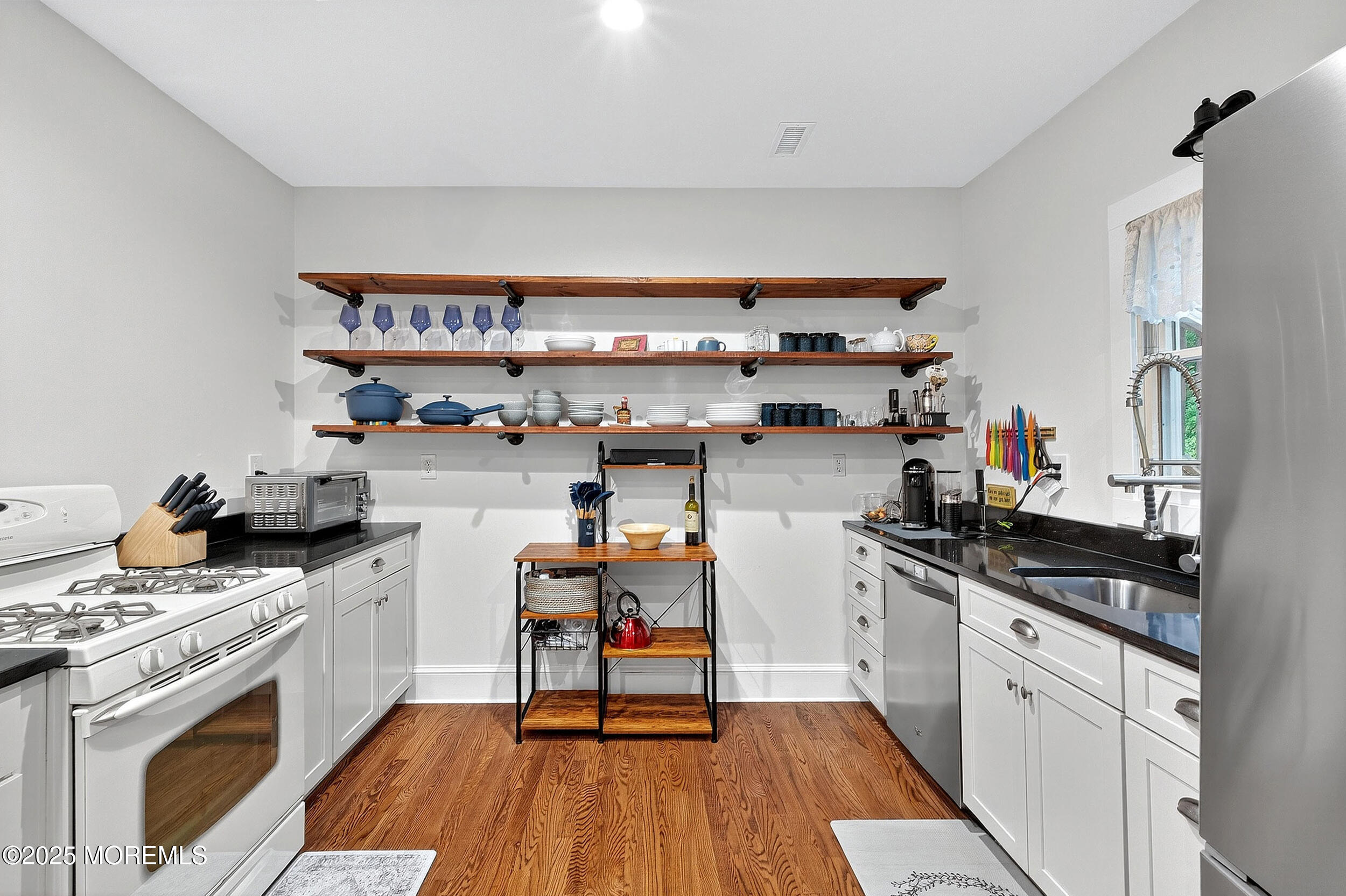 1961 Jumping Brook Road Tinton Falls, NJ 07753 - Photo 33 of 45 a kitchen with stainless steel appliances a stove a sink and cabinets