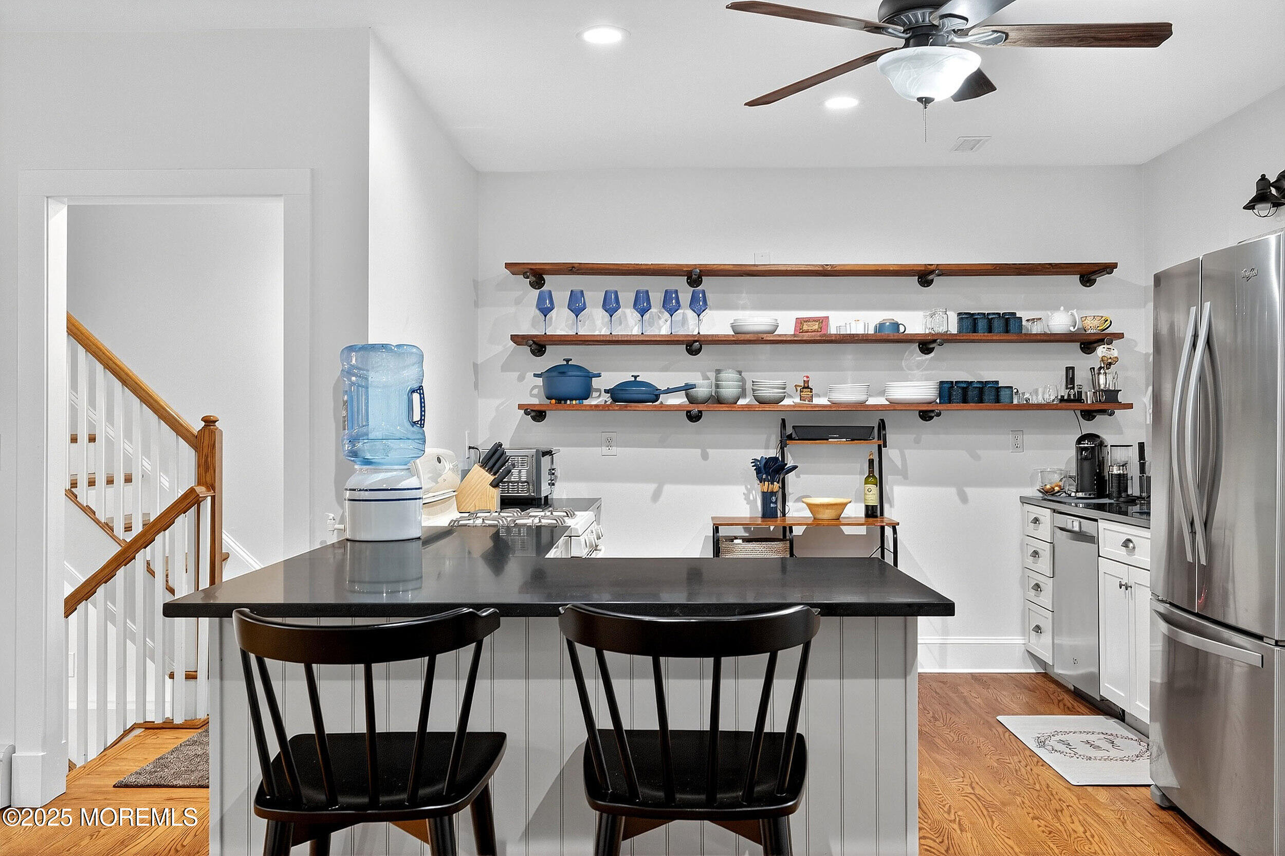 1961 Jumping Brook Road Tinton Falls, NJ 07753 - Photo 37 of 45 a kitchen with stainless steel appliances a dining table chairs and refrigerator