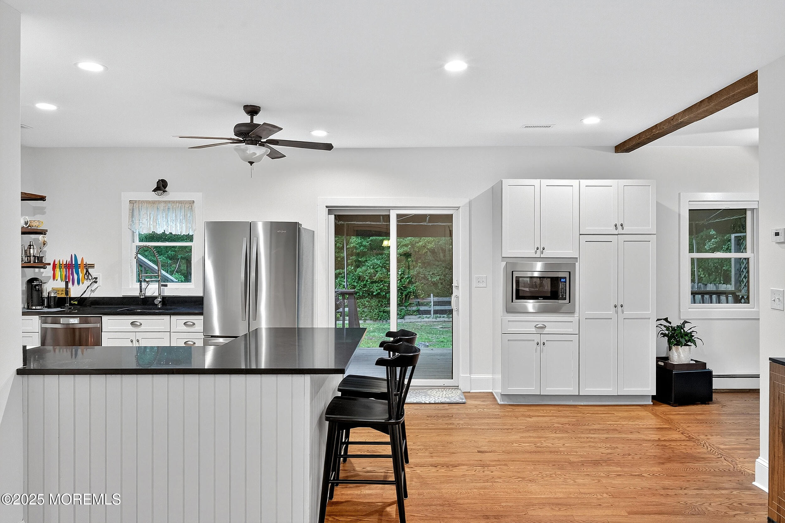 1961 Jumping Brook Road Tinton Falls, NJ 07753 - Photo 38 of 45 a living room with stainless steel appliances kitchen island granite countertop furniture a fireplace and a large window