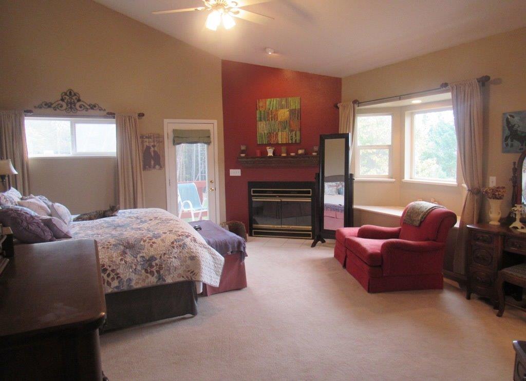 1961 Crow Road Merlin, OR 97532 - Photo 16 of 35 a bedroom with a bed couch and windows