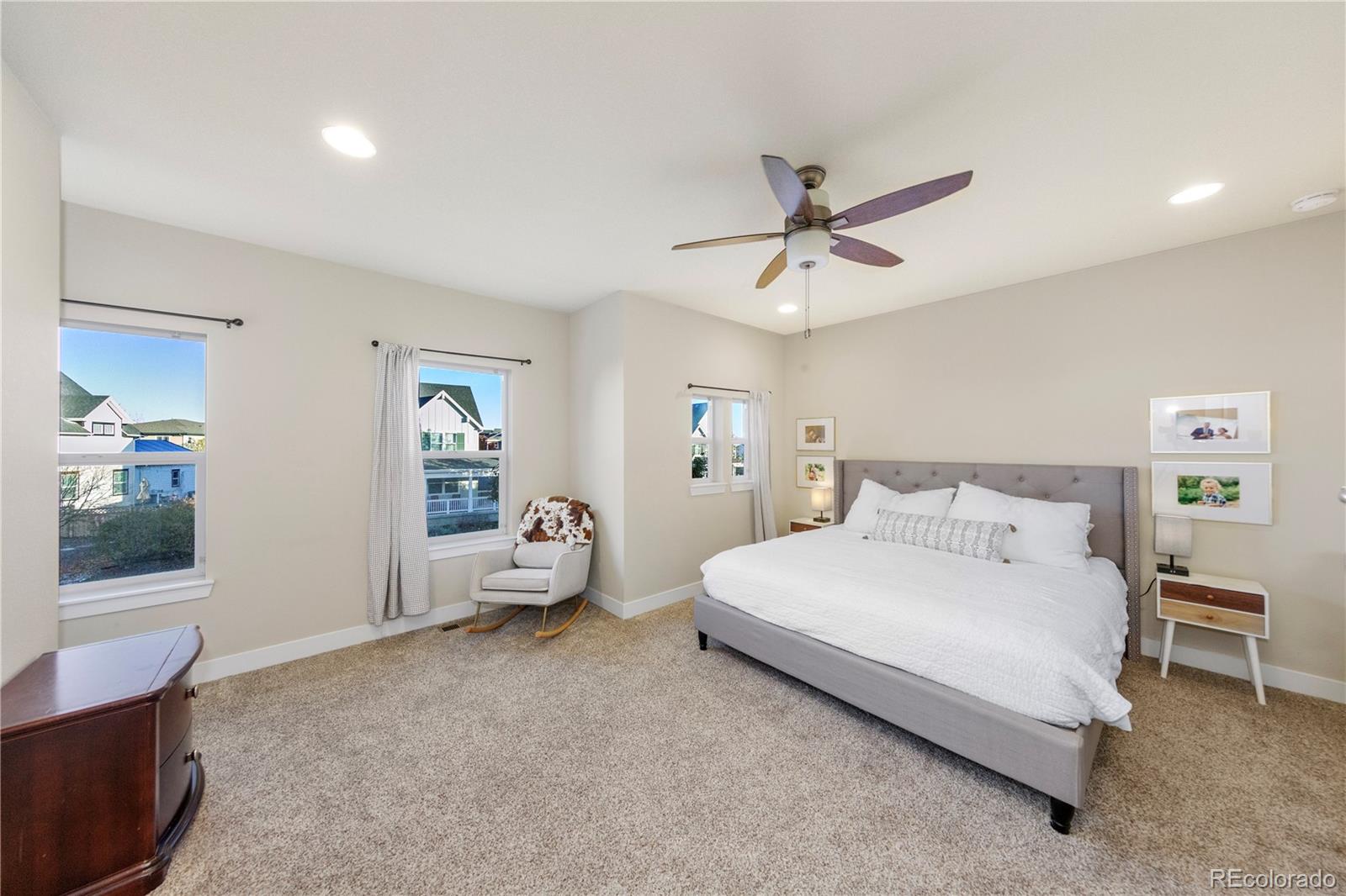 2907 Ironton Street Denver, CO 80238 - Photo 11 of 29 a spacious bedroom with a bed and a couch