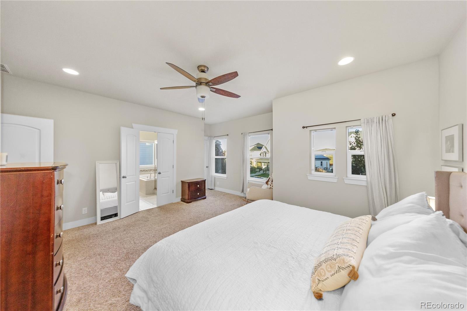 2907 Ironton Street Denver, CO 80238 - Photo 12 of 29 a bedroom with a bed and a chandelier