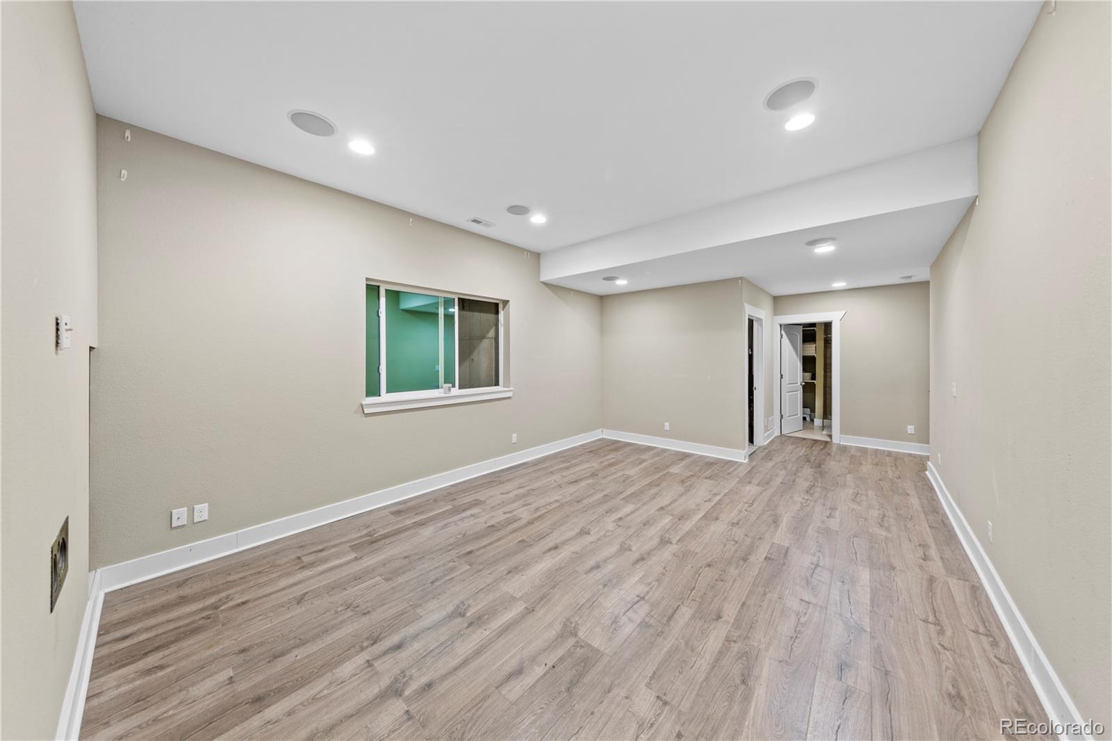 2907 Ironton Street Denver, CO 80238 - Photo 19 of 29 a view of a big room with wooden floor and windows