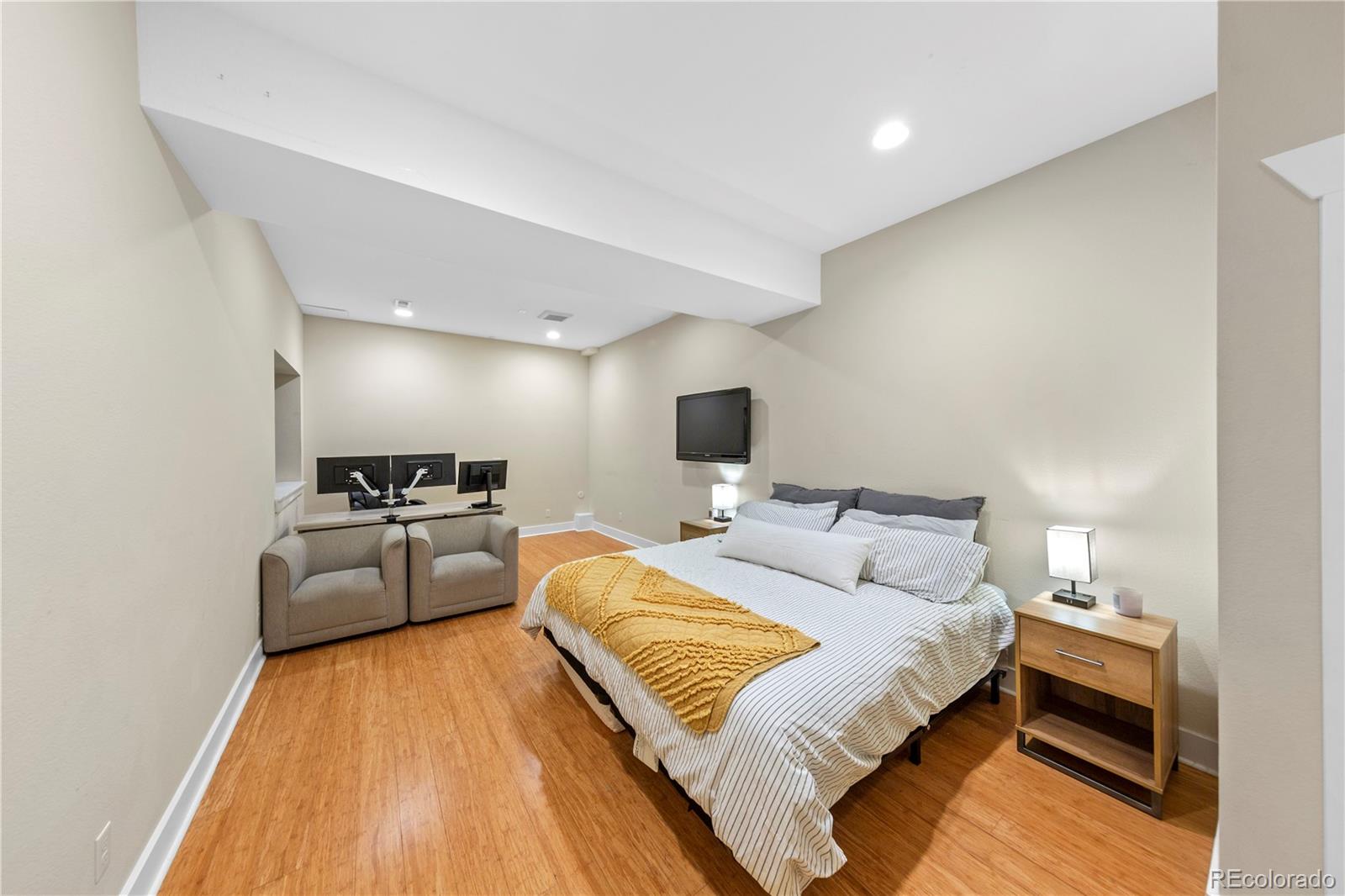 2907 Ironton Street Denver, CO 80238 - Photo 21 of 29 a bedroom with a bed and a couch