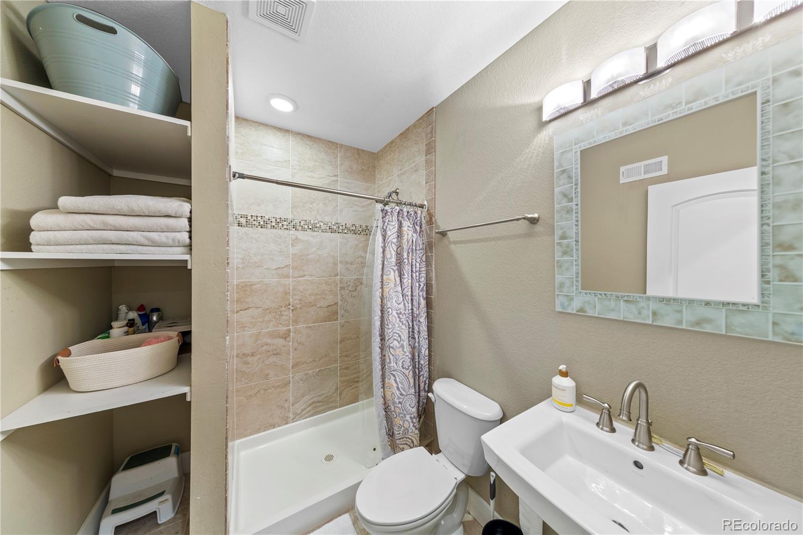 2907 Ironton Street Denver, CO 80238 - Photo 24 of 29 a bathroom with a sink toilet and shower