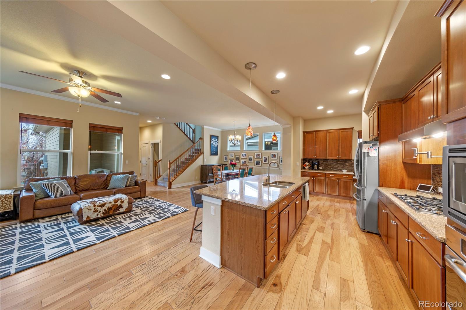 2907 Ironton Street Denver, CO 80238 - Photo 28 of 29 a large kitchen with stainless steel appliances kitchen island granite countertop a large center island and a stove top oven