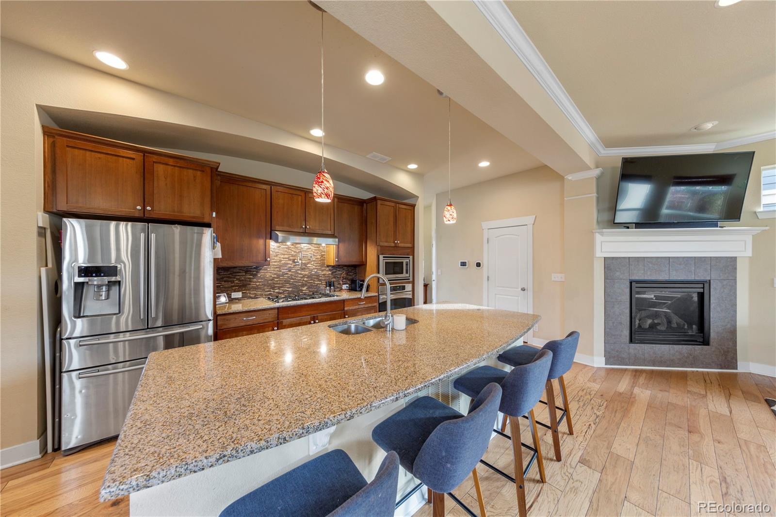 2907 Ironton Street Denver, CO 80238 - Photo 10 of 29 a large kitchen with stainless steel appliances granite countertop a stove and a refrigerator