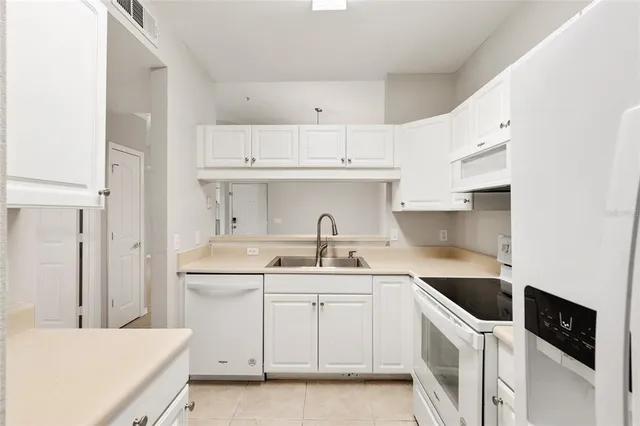 a kitchen with a sink a stove and cabinets