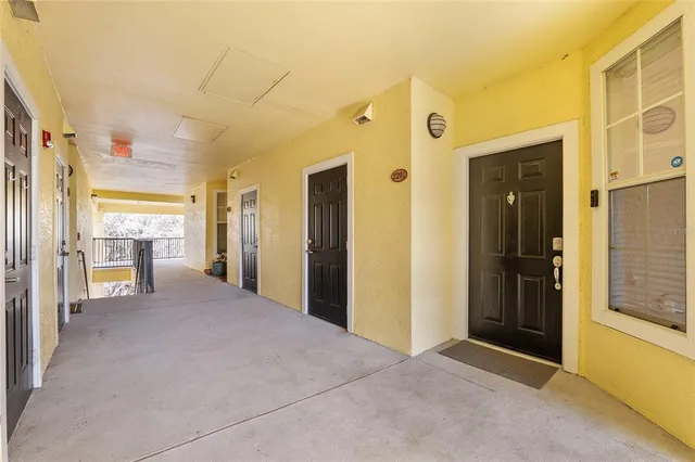 a view of a hallway with wooden shelves