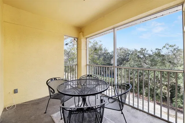 a view of a balcony with table and chairs
