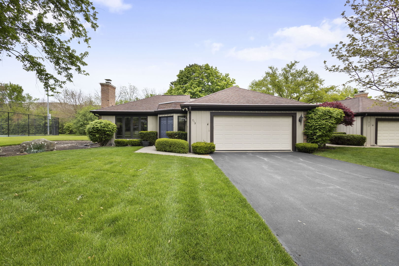 715 Tomlin Drive, Unit A1 Burr Ridge, IL 60527 - Photo 1 of 24 a front view of a house with a yard