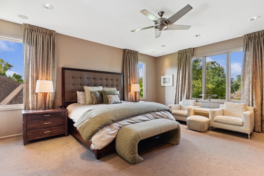 69 Riverside Drive Deerfield, IL 60015 - Photo 12 of 27 a spacious bedroom with a bed a couch and a large window