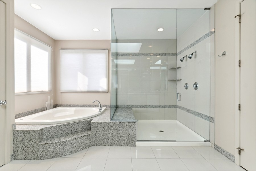 69 Riverside Drive Deerfield, IL 60015 - Photo 13 of 27 a bathroom with a large tub shower and sink