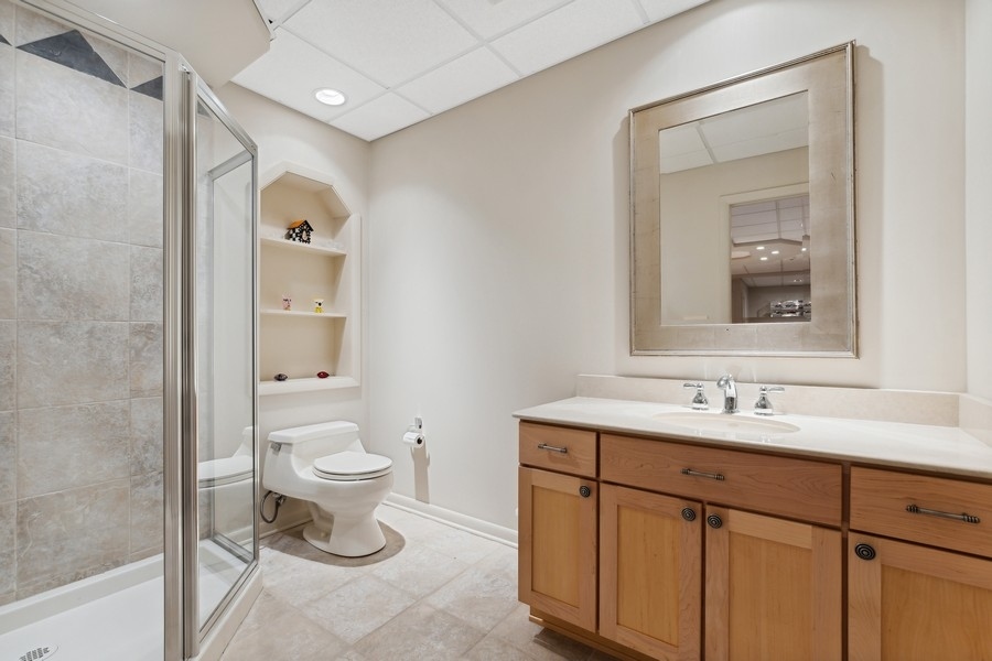 69 Riverside Drive Deerfield, IL 60015 - Photo 21 of 27 a bathroom with a toilet sink and mirror