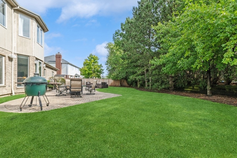 69 Riverside Drive Deerfield, IL 60015 - Photo 23 of 27 a view of a patio with a table and chairs under an umbrella