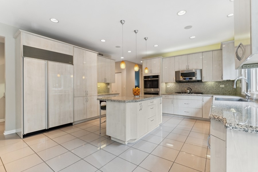 69 Riverside Drive Deerfield, IL 60015 - Photo 5 of 27 a large kitchen with stainless steel appliances lots of white cabinets