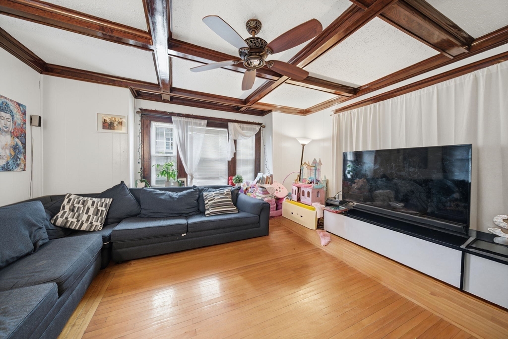 37 Albion Street Methuen, MA 01844 - Photo 2 of 26 a living room with furniture a fireplace and a flat screen tv