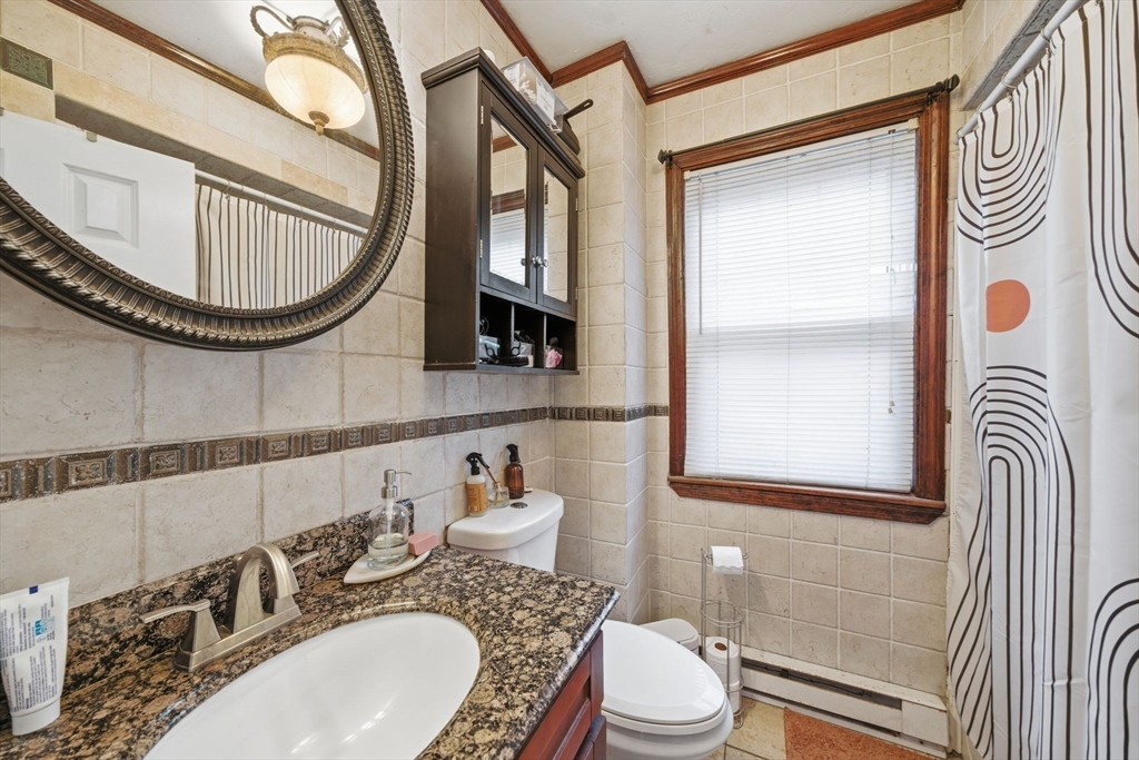 37 Albion Street Methuen, MA 01844 - Photo 8 of 26 a bathroom with a sink a toilet and a mirror