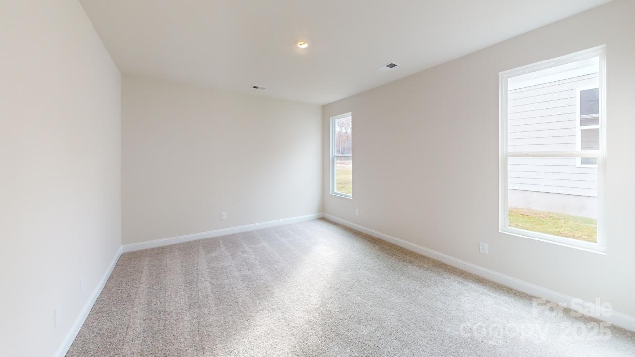 515 Tates Trail, Unit 39 Cramerton, NC 28056 - Photo 15 of 33 an empty room with wooden floor and windows