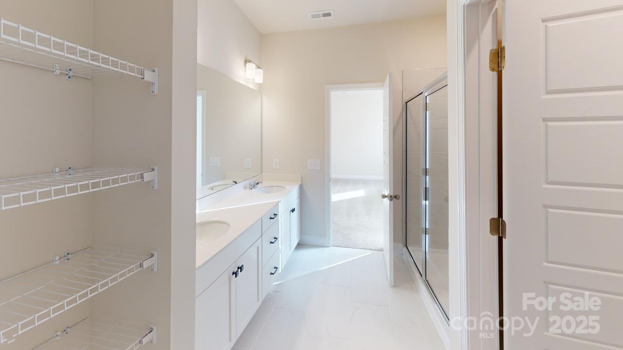 515 Tates Trail, Unit 39 Cramerton, NC 28056 - Photo 16 of 33 a bathroom with a double vanity sink a toilet and shower
