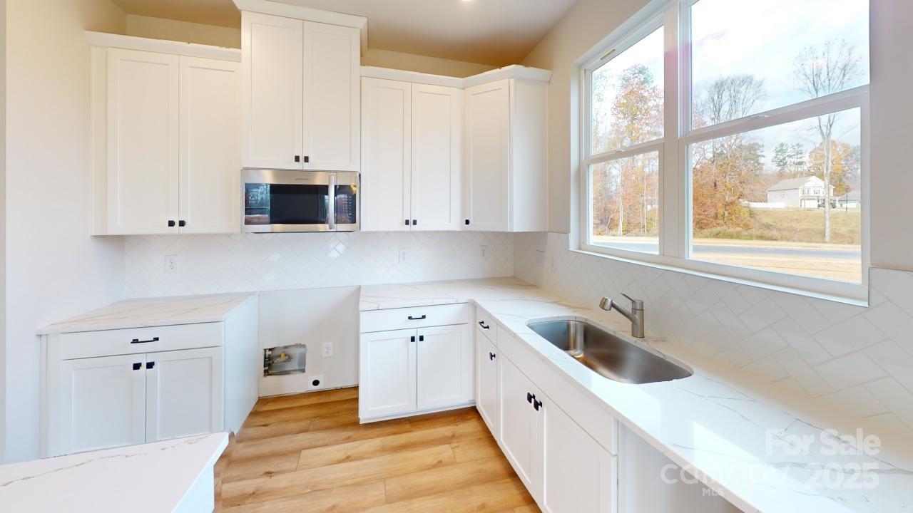 515 Tates Trail, Unit 39 Cramerton, NC 28056 - Photo 3 of 33 a kitchen with white cabinets and a sink