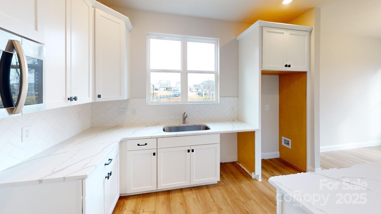 515 Tates Trail, Unit 39 Cramerton, NC 28056 - Photo 4 of 33 a view of a kitchen with wooden floor and electronic appliances