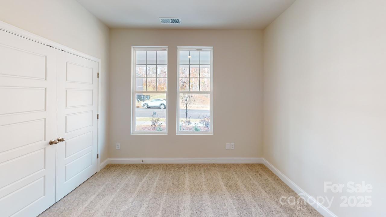 515 Tates Trail, Unit 39 Cramerton, NC 28056 - Photo 9 of 33 an empty room with wooden floor and windows