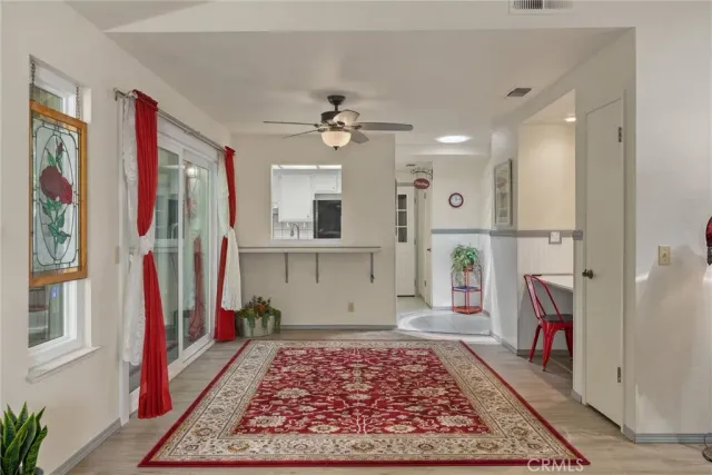 a kitchen with stainless steel appliances granite countertop a stove a refrigerator a dining table and chairs