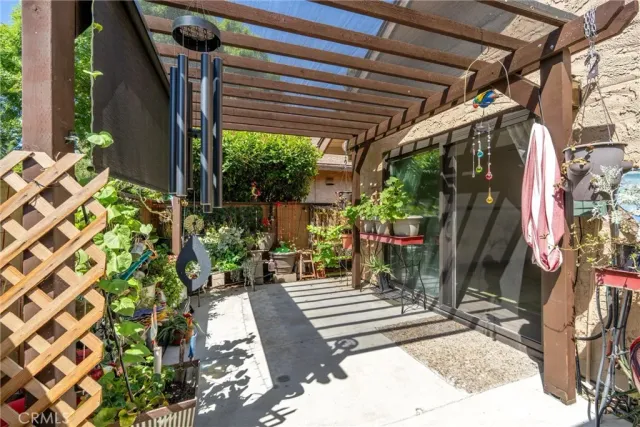 a view of a brick house with a large windows and plants