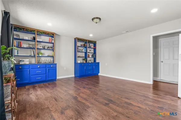 a view of workspace with furniture and wooden floor
