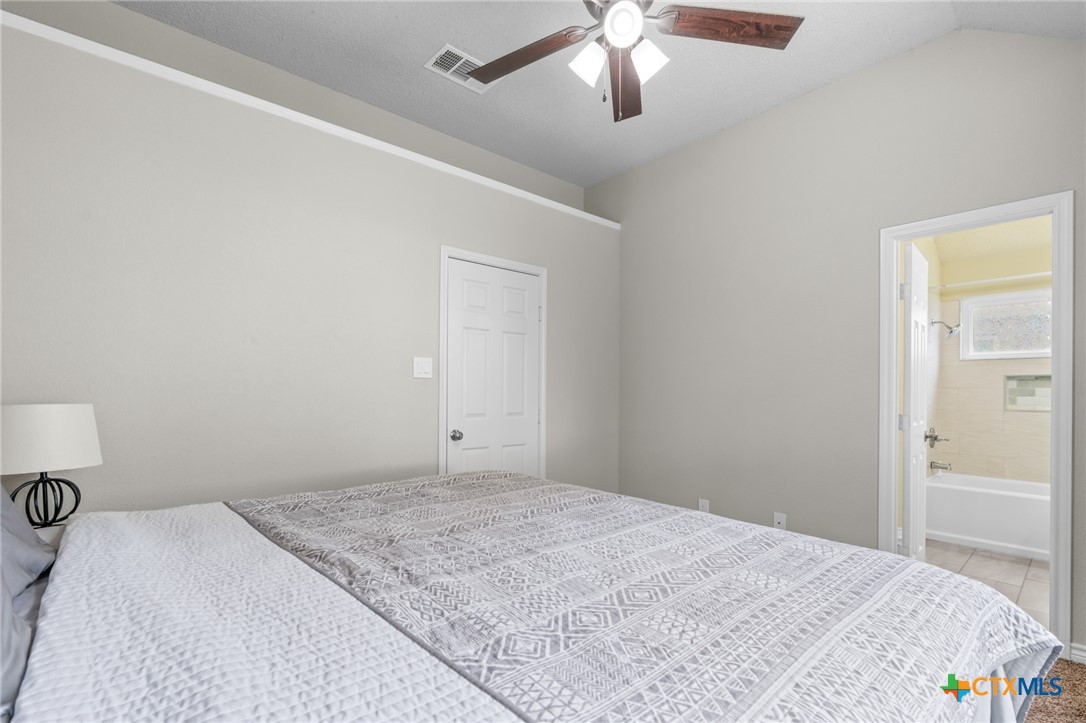 2804 Bluejay Drive Killeen, TX 76549 - Photo 18 of 36 a bedroom with a bed and a chandelier