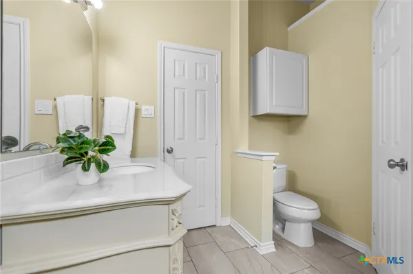 a bathroom with a sink a toilet and a mirror