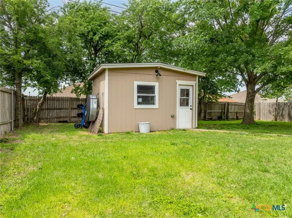 a view of a backyard with a large tree