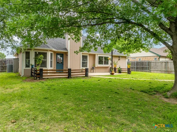 a front view of house with yard and outdoor seating