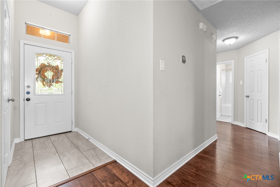 2804 Bluejay Drive Killeen, TX 76549 - Photo 5 of 36 an empty room with wooden floor and painting on the wall