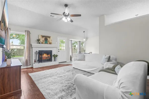 a living room with furniture and a fireplace